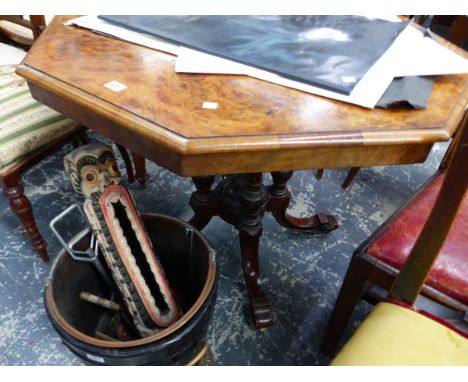 A VICTORIAN BURR WALNUT OCTAGONAL TABLE SUPPORTED ON FOUR COLUMNS AND SWEPT LEGS WITH WHITE CERAMIC CASTER FEET.   W 92 x D 9