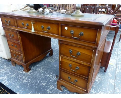 A 20th C. PEDESTAL DESK, THE LEATHER INSET TOP ABOVE A KNEEHOLE DRAWER FLANKED BY BANKS OF FOUR ON BRACKET FEET.   W 120.5 x 