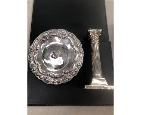 A HALLMARKED SILVER CORINTHIAN COLUMN CANDLESTICK AND AN EASTERN WHITE METAL SMALL FOOTED SALVER.