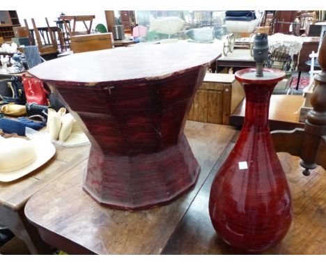 AN EASTERN RED LACQUER POLYGONAL DRUM TABLE.   W 64 x D 64 x H 48cms. TOGETHER WITH A SIMILAR BLACK RINGED RED LACQUER BALUST