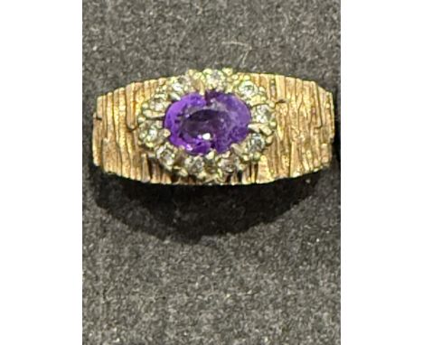 9ct Gold ring set with central amethyst surrounded by diamonds Weight 6.8g Size R Weight 