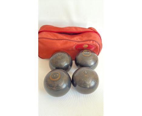 Set of four vintage lawn bowls, marked 'S.V.T.', with red carrying case, from the mid-20th century.