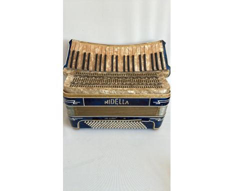 Midella De Luxe IV piano accordion, blue and gold finish, with mother-of-pearl keys and intricate grille design.