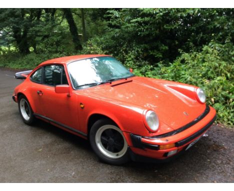 A 1989 Porsche 911 Carrera SC, registration number F98 FWE, Guards red. Porsche's 911 became available with the larger 3.2 li