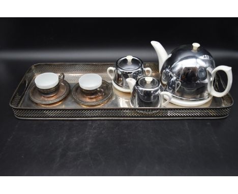 An Art Deco tea set for two with silver plated tray. To include a ceramic teapot, milk jug, sugar bowl and with stainless ste