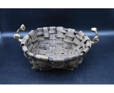 A contemporary wicker log or fruit basket with brass handles, designed by David Marshall. H.18 Dia.43cm 