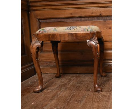 An early 20th century early Georgian style carved walnut stool with drop in tapestry seat. H.48cm 