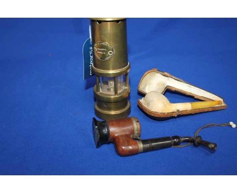 BRASS MINER'S LAMP
together with three vintage pipes, two wooden, the other clay with an amber mount piece and a case (4)