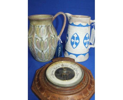 SIGNED DENBY JUG
by Glyn College, with pastel tone foliate decoration, 21cm high; together with a 19th century ironstone jug 