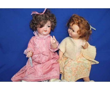 GERMAN BISQUE DOLL 
in a pink lace dress, together with another vintage doll (2)