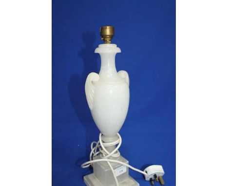 CARVED WHITE ALABASTER URN SHAPED LAMP
in the form of a tapering twin handled urn on a square plinth base, 38cm high