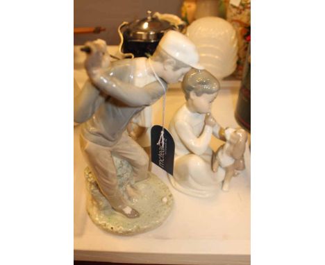 THREE LLADRO FIGURES
including a figure of a golfer, a pair of choir boys and a figure of a child and a dog, largest 28cm hig