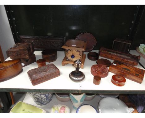 A collection of carved wooden items, including incense burner, trinket pots, trays etc. 