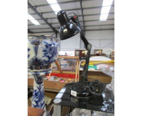 A black angle poise lamp.