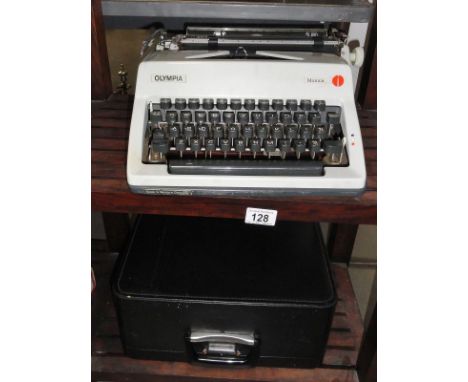 A cased olympia monica typewriter (needs ink).