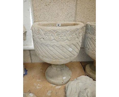 A Mayan circular planter decorated with Aztec design.
