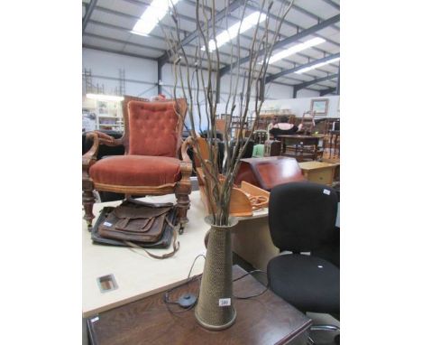 A table lamp in the form of a vase of twigs.