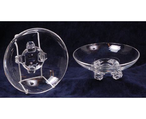 A pair of crystal clear glass table bowls by Steuben, each of circular form and raised on four scroll supports, engraved 'Ste