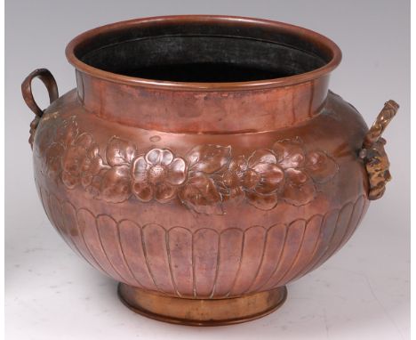 An Art Nouveau embossed copper and twin brass handled planter, of shouldered bulbous tapering form, having stylised floral ba