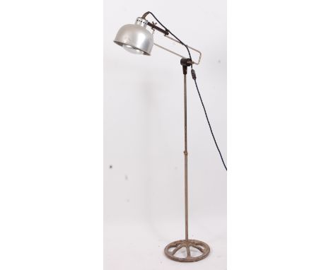 A 1960s industrial chrome, aluminium and cast iron standard lamp, of rotating and telescopic form, having integral domed shad