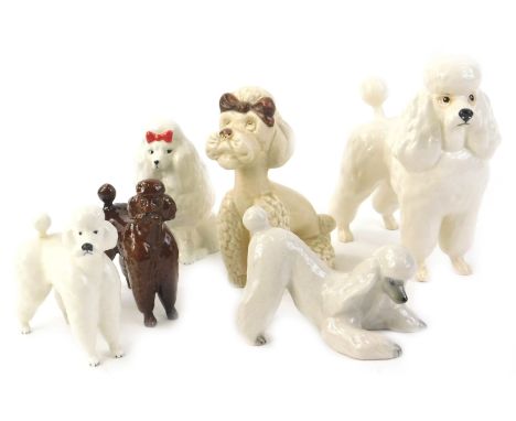 A collection of Beswick and other ceramic poodles, various sizes and designs