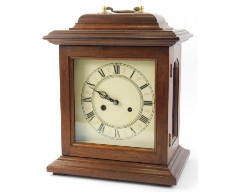 A German mantel clock, the printed dial with Roman numerals, in a mahogany case with brass handles, 36cm H.