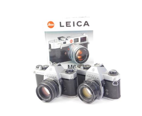 Two Pentax Spotmatic cameras with lenses, and a Leica M6-M1 3rd edition manual