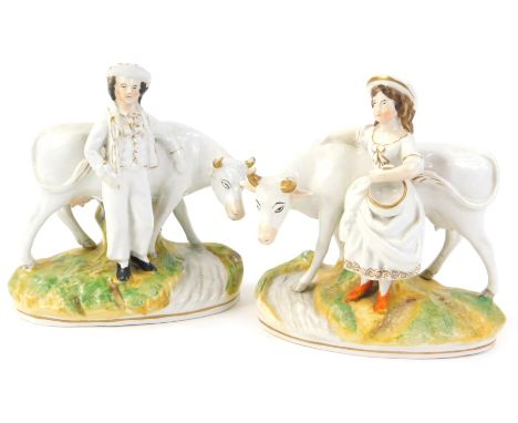 A pair of Staffordshire ceramic models of cows, cows modelled with a male and female, (AF), 16cm W.