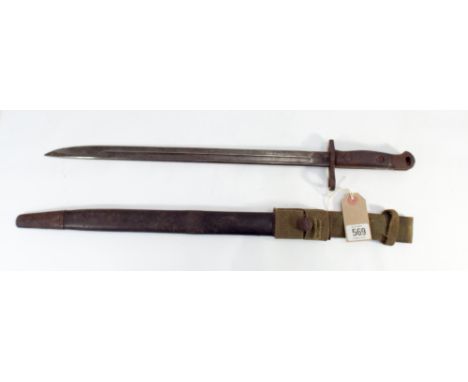 A British army bayonet in its leather covered metal mounted scabbard and complete with canvas frog. Wooden grips to handle, b