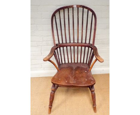 An antique stick back Windsor elbow chair on turned legs 