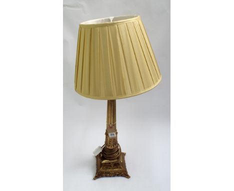 A brass corinthian column table lamp with shade 