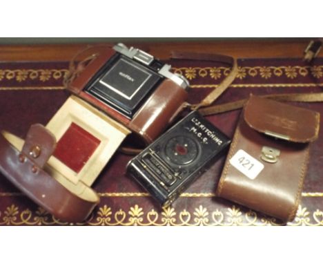 Two old collectable cameras a Zeiss Icon and a Kodak vest pocket camera 