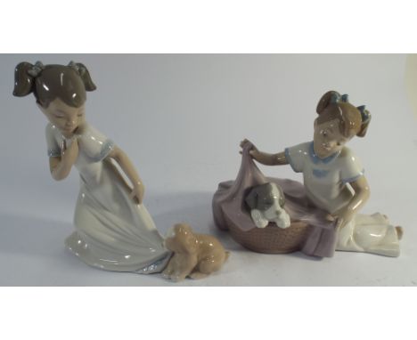 Two Nao figurines girls playing with puppies 