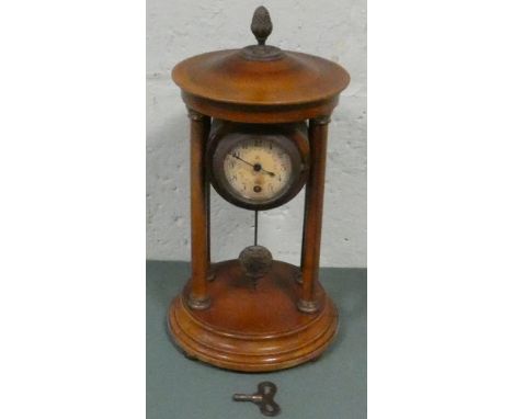 A Victorian Empire style mantle clock in mahogany case with pillars 13" high to top of finial   Clock appears to be working