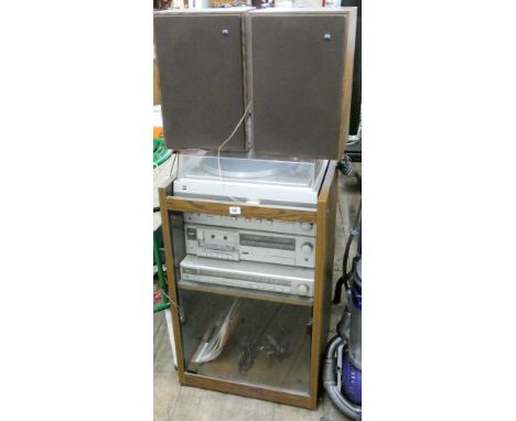 A Dual record deck, amplifier, tape deck etc in a cabinet with two speakers 