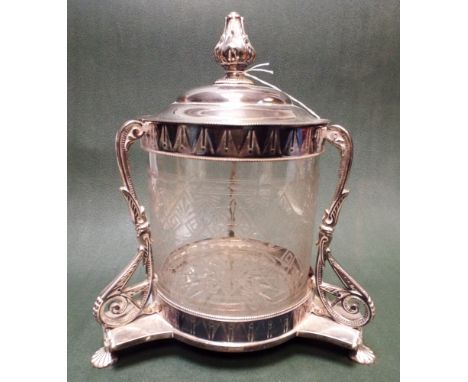 A silver plated and cut glass biscuiteer standing on a tripod style base with three scrolled feet height including finial is 