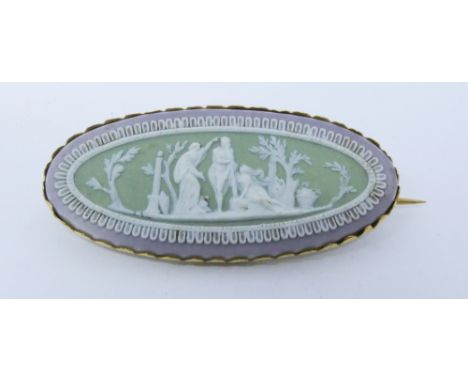 A Wedgwood lilac and green Jasper oval panel brooch, stamped Wedgwood to reverse in an unmarked yellow metal frame tests as 9