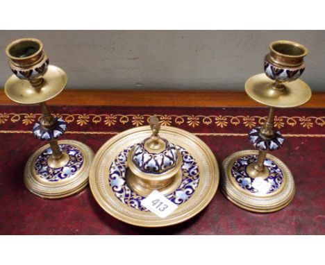 A French deep blue and powder blue cloisonne enamel desk set comprising a pair of candlesticks and a circular inkwell