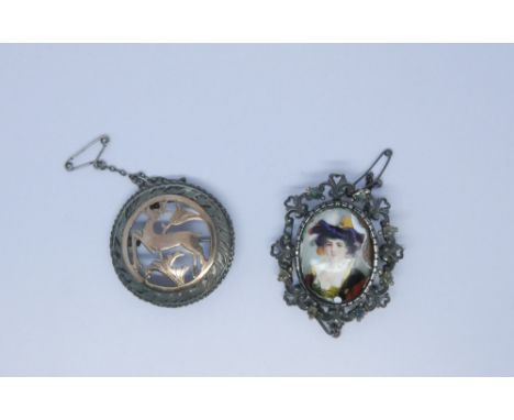 A medieval style enamel set portrait brooch the frame set with gems and a circular leaping stag motif Art Deco brooch, length
