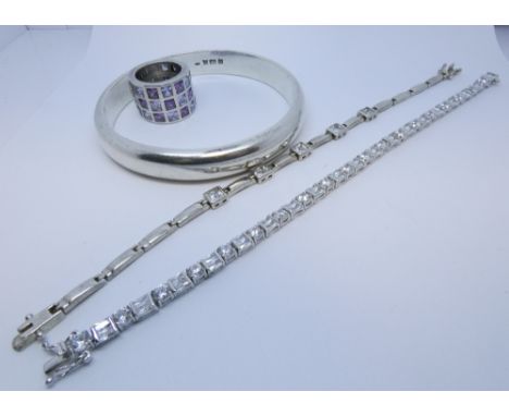 A solid silver bangle, wide silver and paste set dress ring and two CZ set silver line bracelets gross weight of lot 164gms 