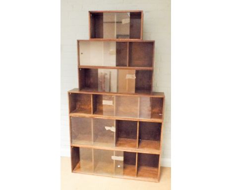 A sectional oak step down bookcase unit with sliding glass doors 108cms wide at the widest point, bears label to reverse - ex