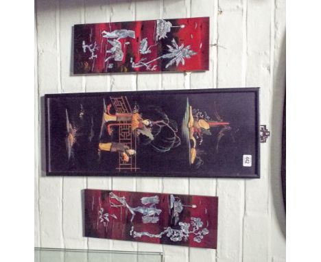 A pair of Chinese lacquered and figure decorated panels and a larger lacquered panel 