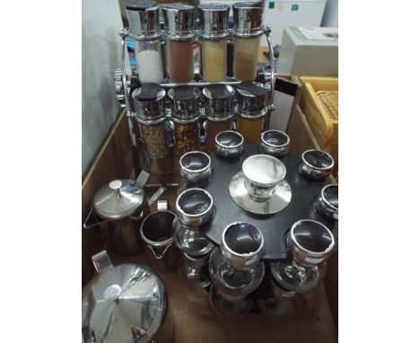 Two spice rack, one complete the other almost complete and a chrome finished tea/coffee and milk jug 