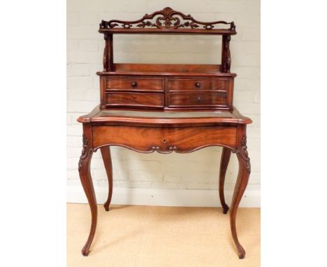 A Victorian mahogany serpentine front ladies writing desk with drawer and shelf back fitted one long drawer standing on cabri