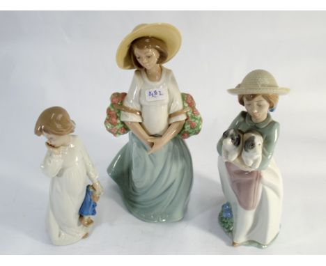 A collection of three Nao porcelain figurines of girls 