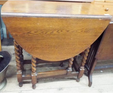 An oval oak barley twist gate leg dining table 2'6 wide 