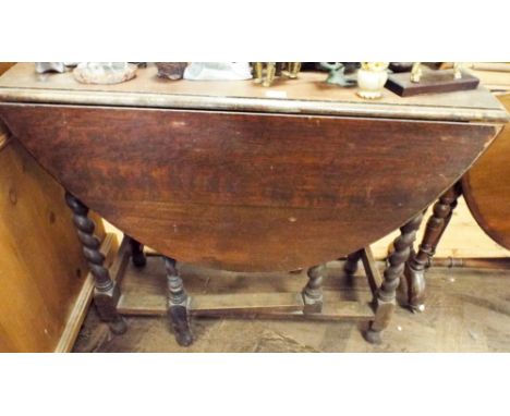 An oval oak gate leg table on barley twist legs 3' wide 