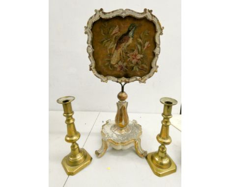 A small Victorian face table screen with needlework panel and a pair of brass candlesticks