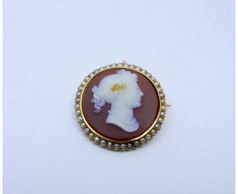 19th century hardstone circular cameo brooch, the Cornelian and white agate layered cameo carved depicting the portrait of a 