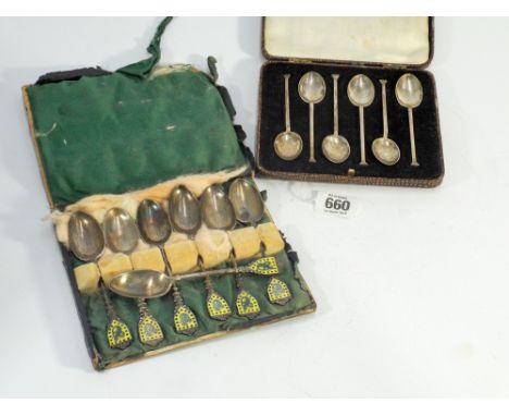 Seven matching enamel topped silver teaspoons together with a set of six seal topped silver spoons.